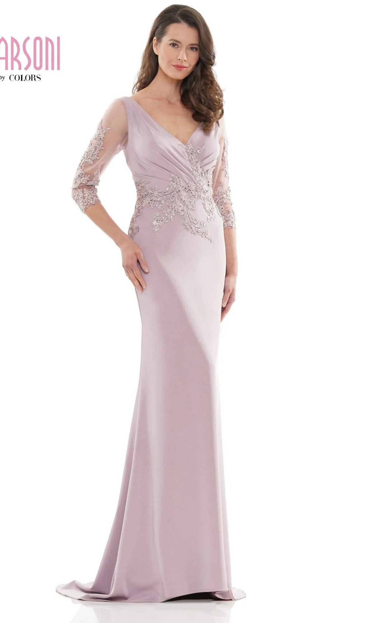 A woman wears the Marsoni MV1145 long formal dress in dusty rose, featuring sheer sleeves and intricate beaded embellishments on the bodice and sleeves.